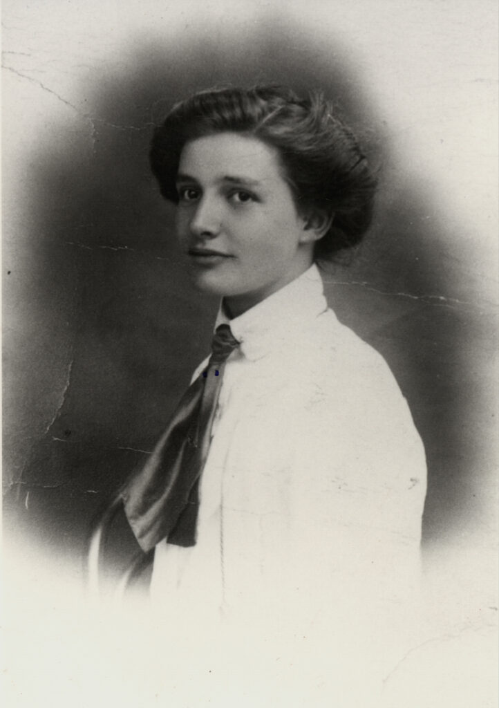 Black and white head and shoulders photograph of a lady wearing a white shirt.