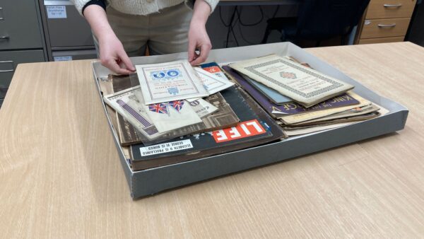a pair of hands getting documents out of a box