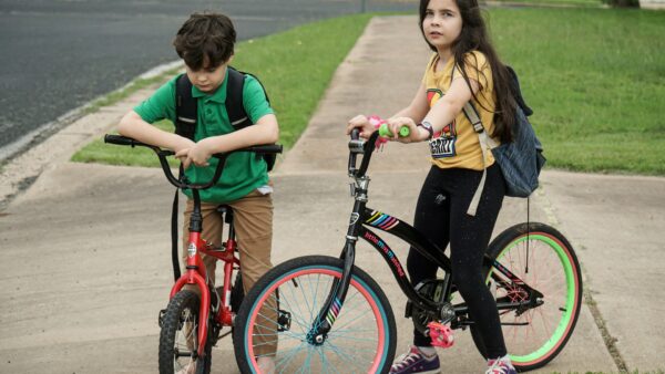 two children on bikes standing still