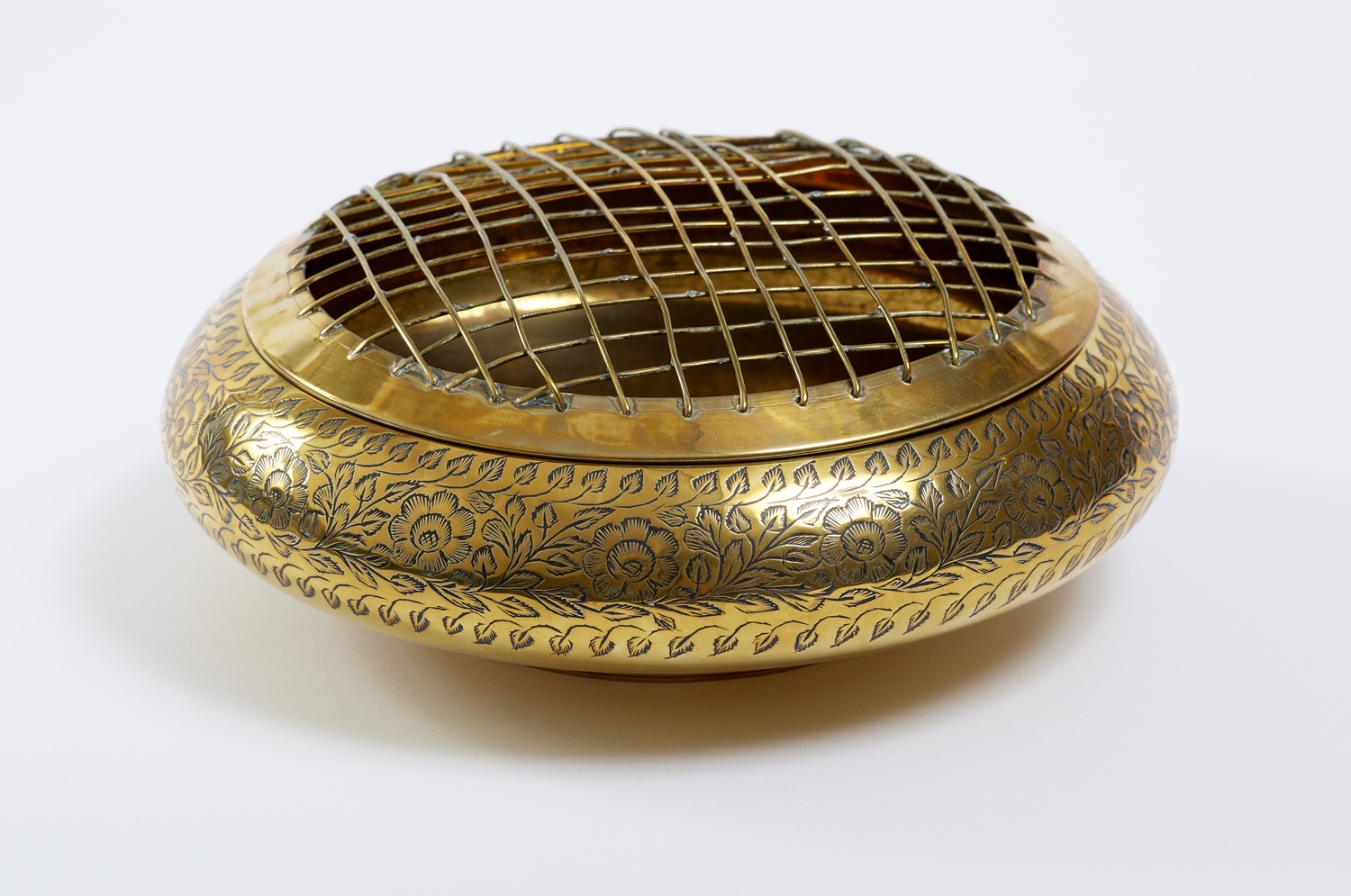 A gold bowl with a mesh lid.