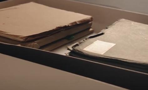 two paper folers with papers hanging out